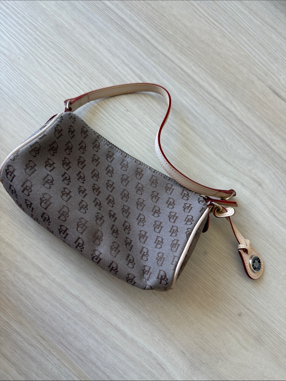 Dooney & Bourke Beige Monogram Wristlet with Red-Trim Strap